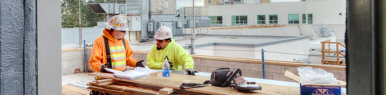 Construction workers reviewing documents